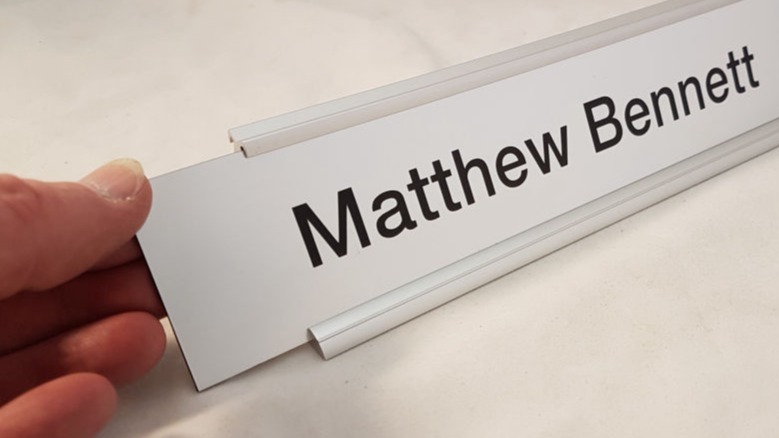 desk name bar showing the name plate being changed in the frame
