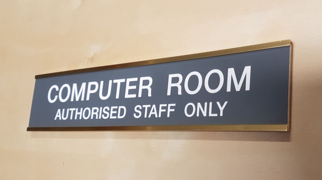 Door mounted name bar with a polished gold frame