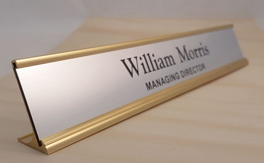 Gold aluminium frame with a brushed aluminium coloured name insert